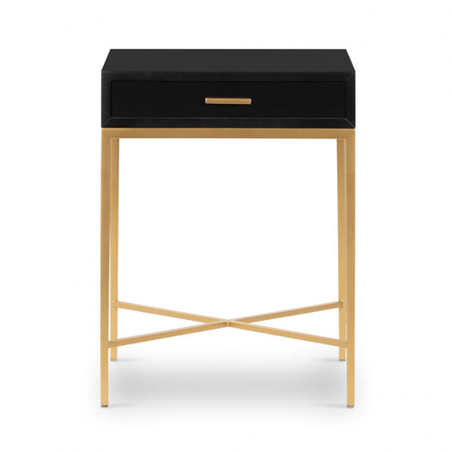 Black side table with a drawer and brass finish legs on a white background