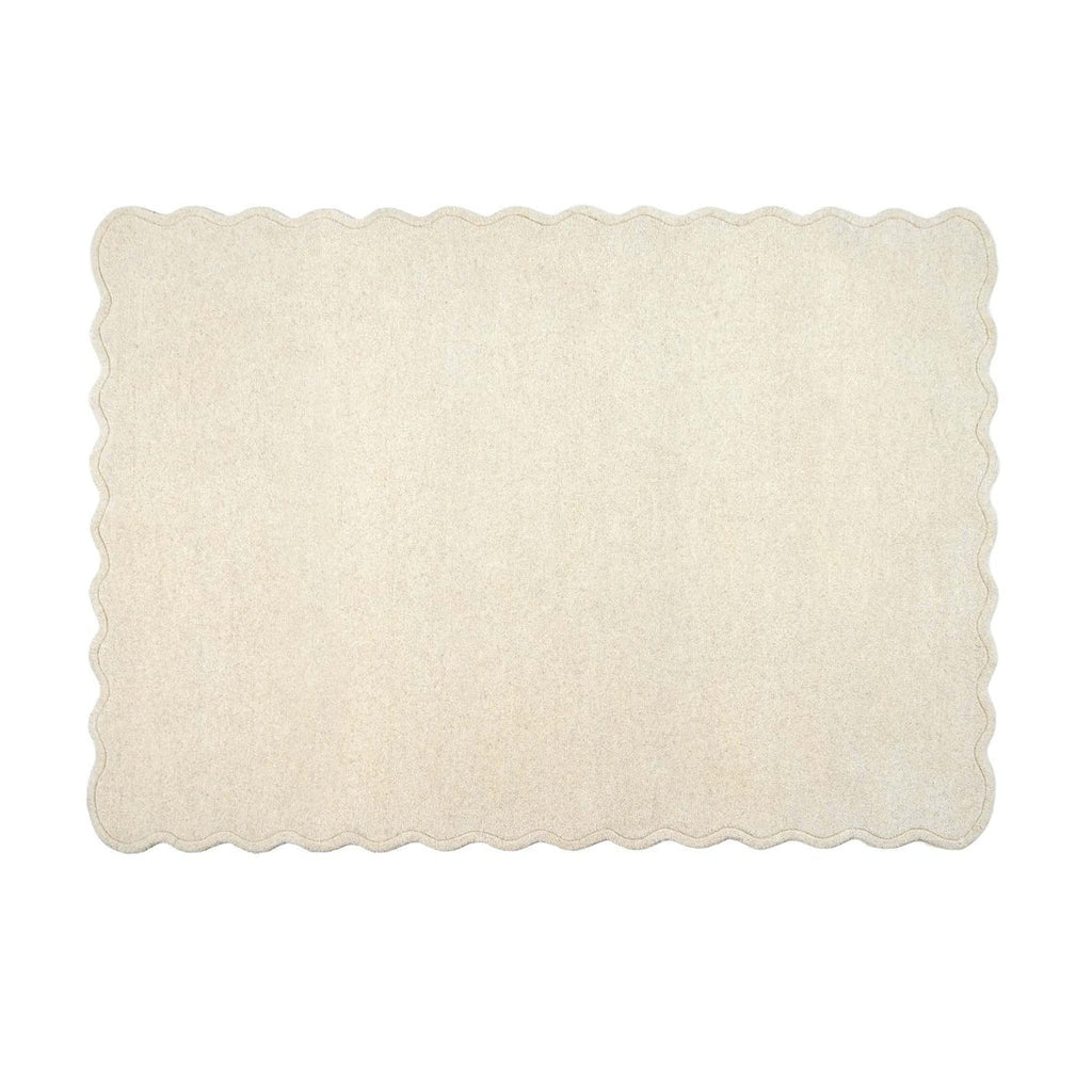A rectangular cream-colored rug with scalloped edges, shown flat against a solid white background.