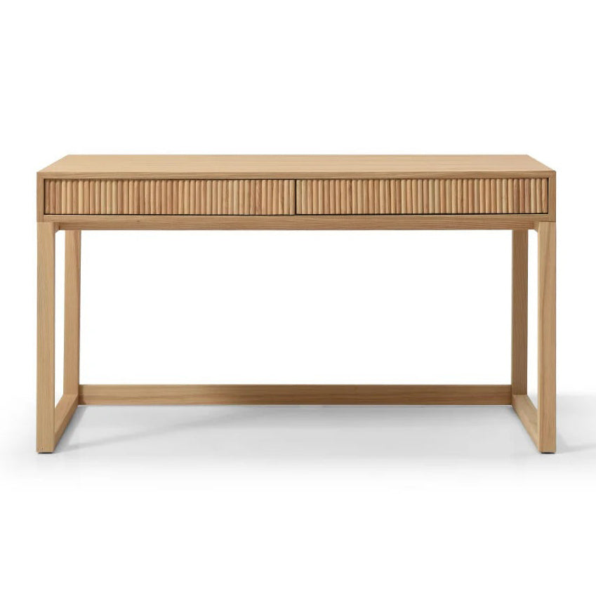 A light natural wood writing desk with two drawers featuring vertical slat fronts and a matching  top, supported by four angled legs, shown against a plain white background.