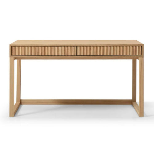 A light natural wood writing desk with two drawers featuring vertical slat fronts and a matching  top, supported by four angled legs, shown against a plain white background.