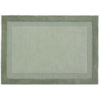 Green rug with a border on a white background