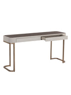 A modern writing desk with a light beige upholstered frame, a dark brown wood-grain top, and curved metallic bronze legs, shown with one drawer pulled out against a plain white background.