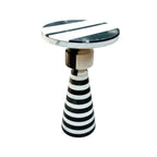 Side table with black and white striped design on a white background